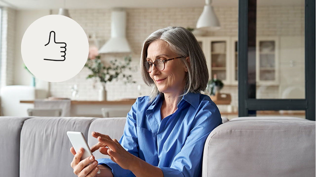 woman sitting on a couch using a smartphone