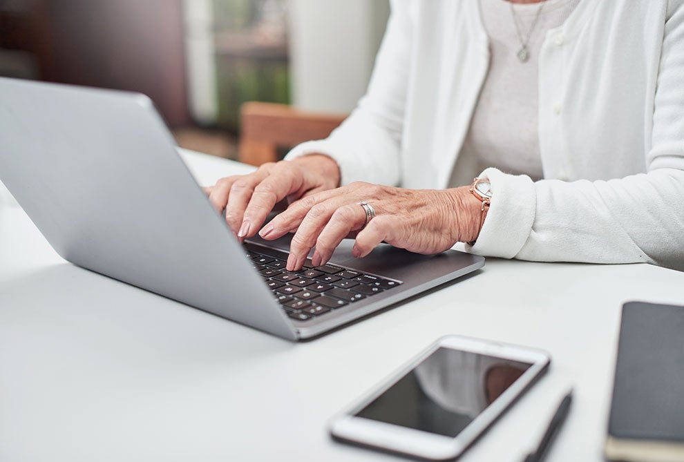 An older person using a laptop