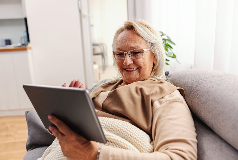 smiling senior woman using a tablet